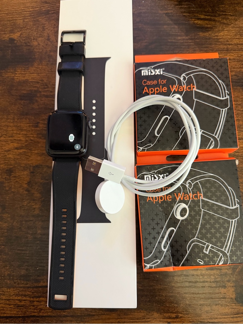 Apple Black Smartwatch with Black Silicone Band and White Magnetic Charger